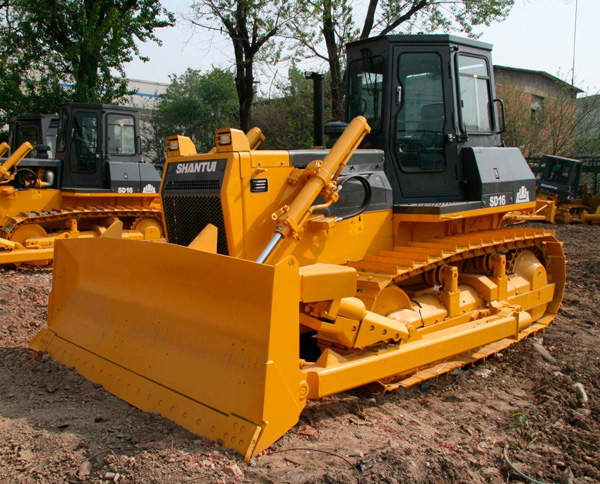 Construction workers operating machinery